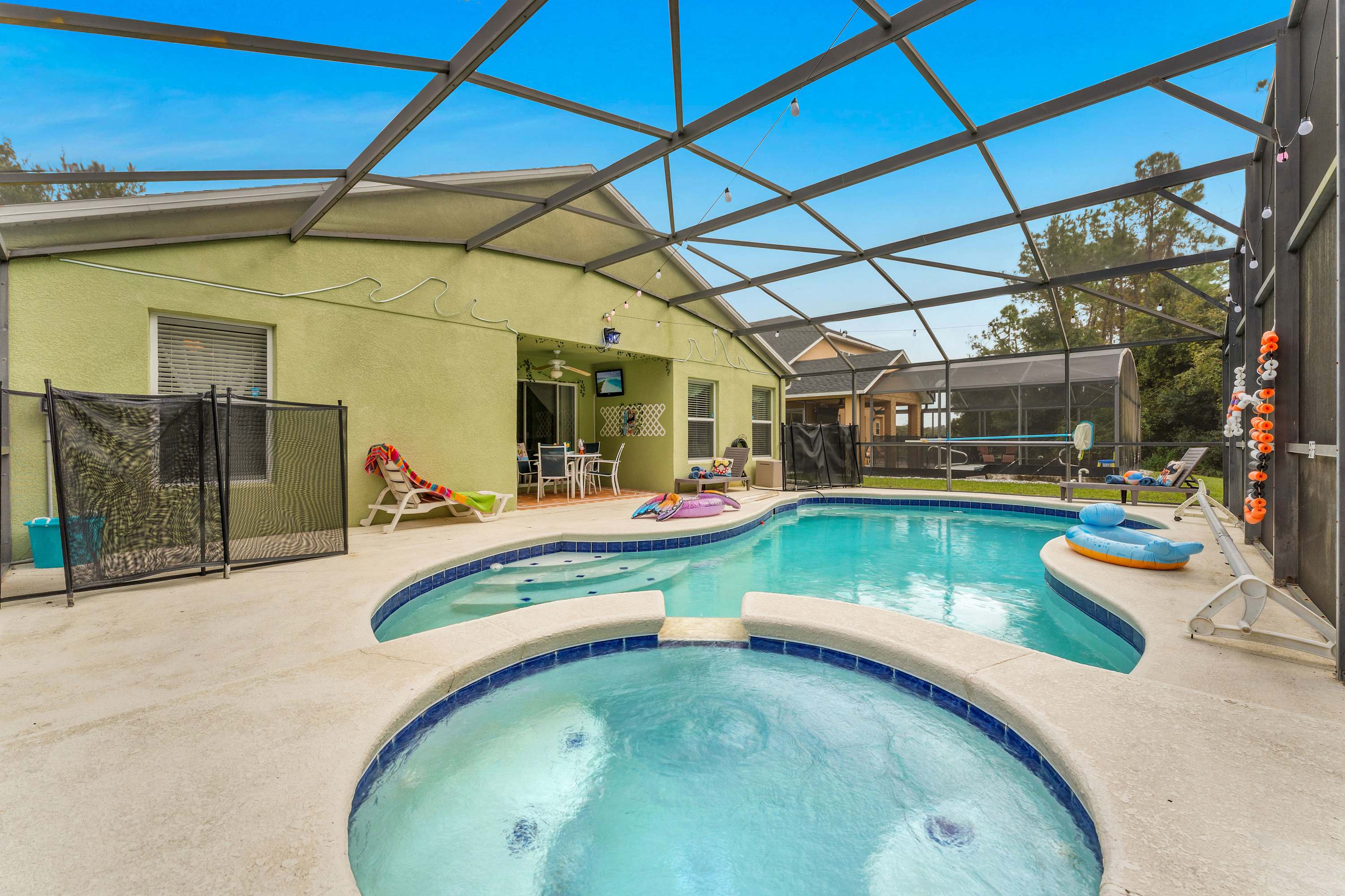Swim, soak, and unwind in your backyard oasis, complete with a pool and hot tub on the covered patio​
