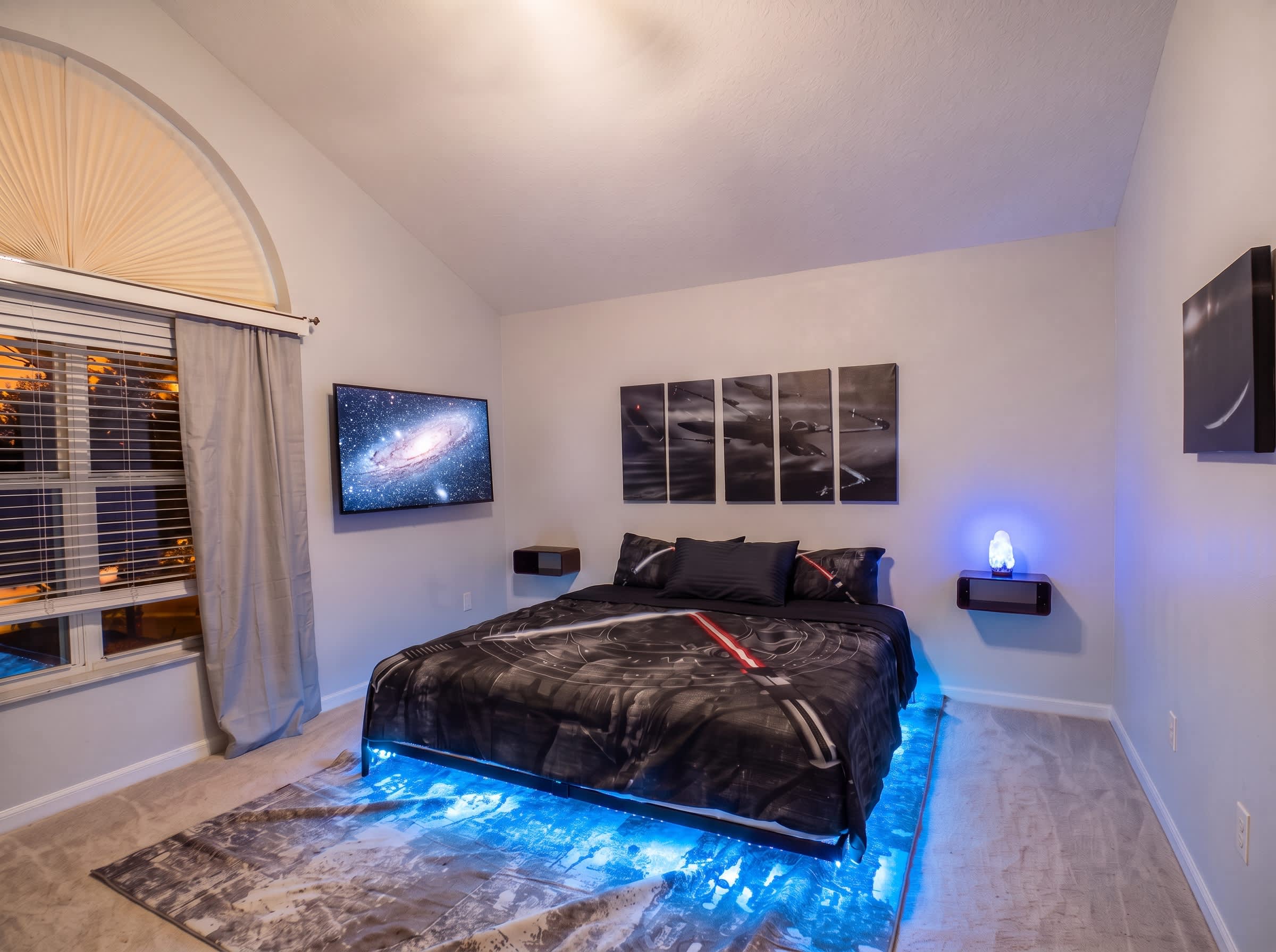 May the Force be with you in this Star Wars-themed king bedroom, featuring a Smart TV, dedicated workspace, and pool views​