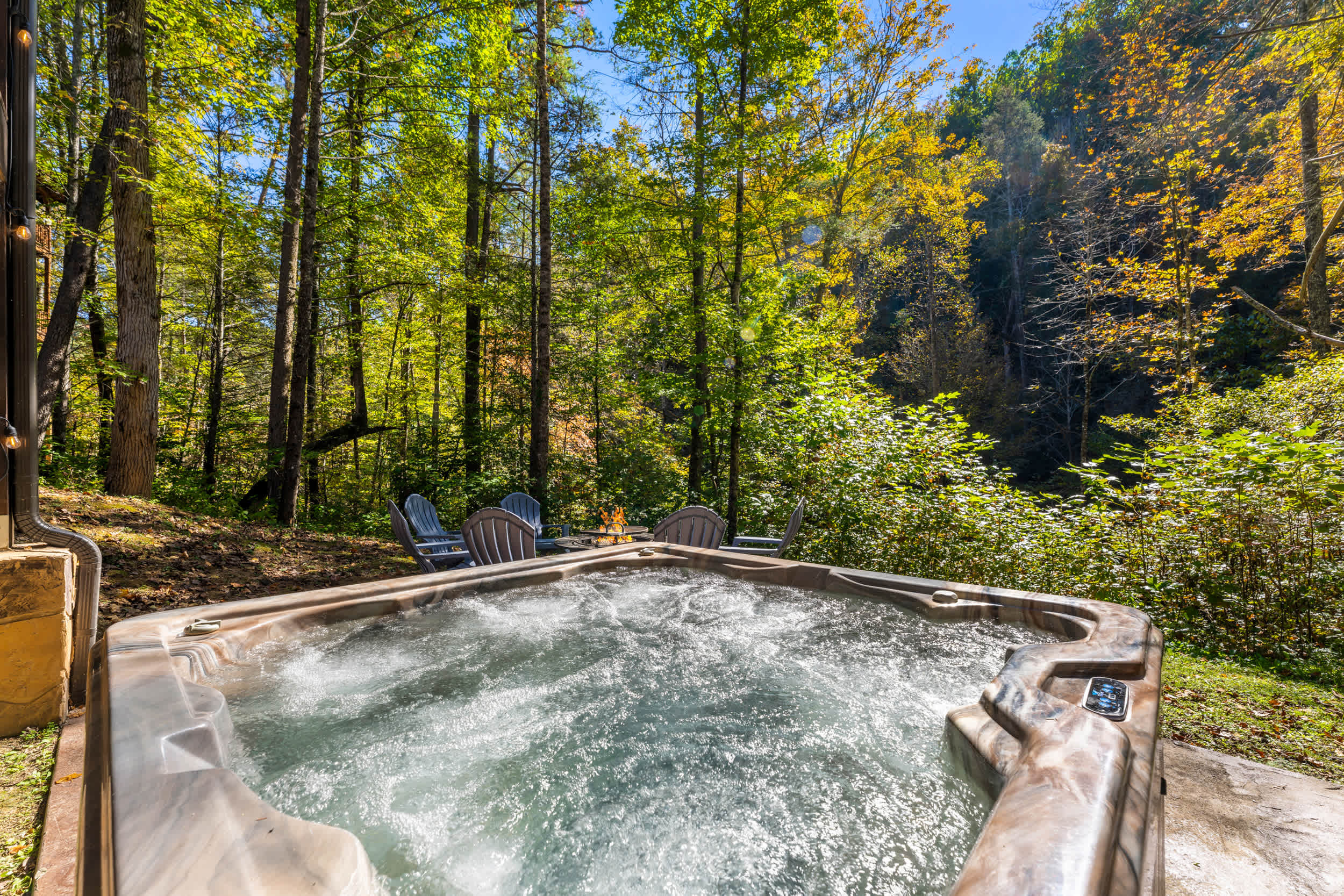 Soak in the outdoor hot tub or gather around the backyard fire pit surrounded by wooded nature.