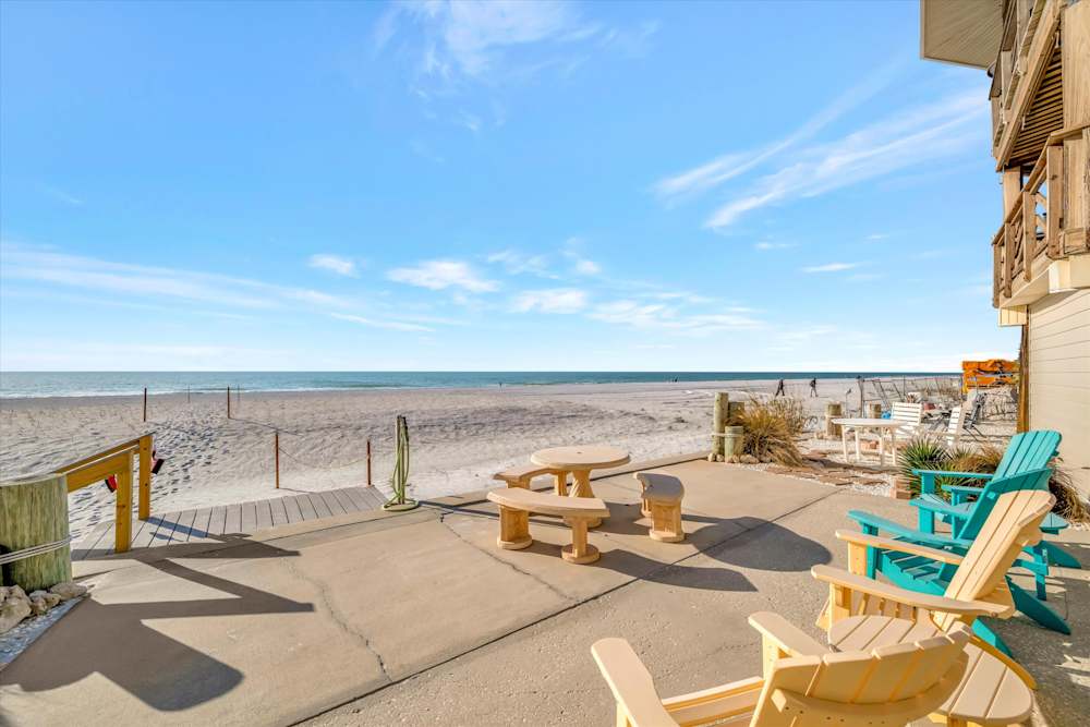 Beachfront seating just steps from the sand at the back side of your lovely unit.