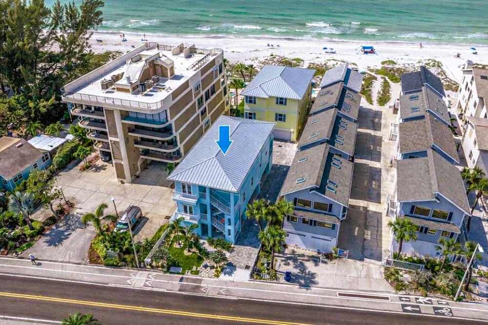 Aerial view of beachfront property and surroundings