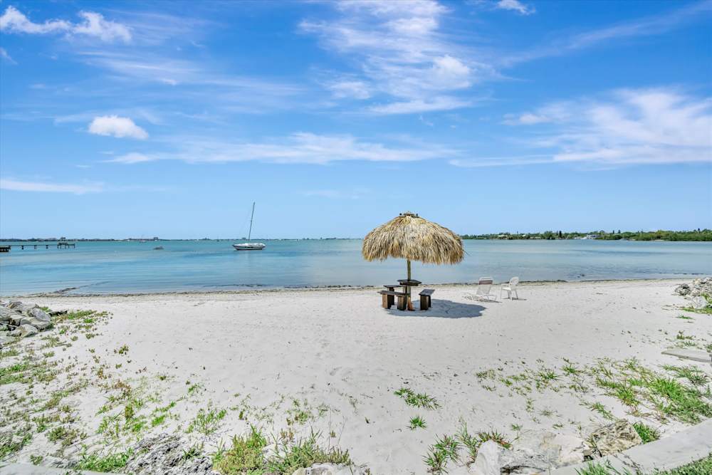 Sandy beach with lounge chairs and shade