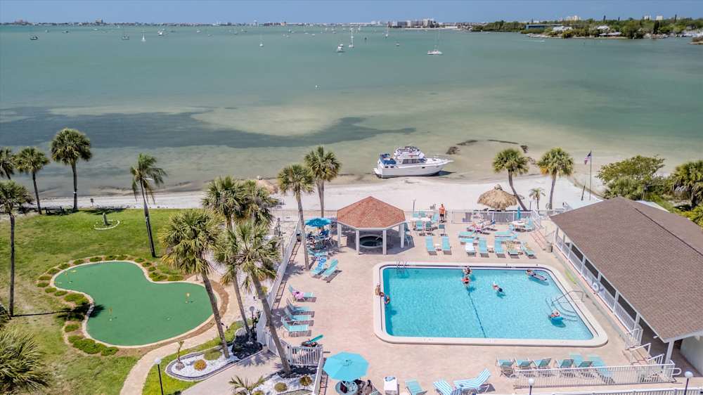 Community pool complex with beachfront access