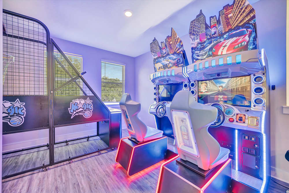 Basketball shootout game beside dual racing simulators