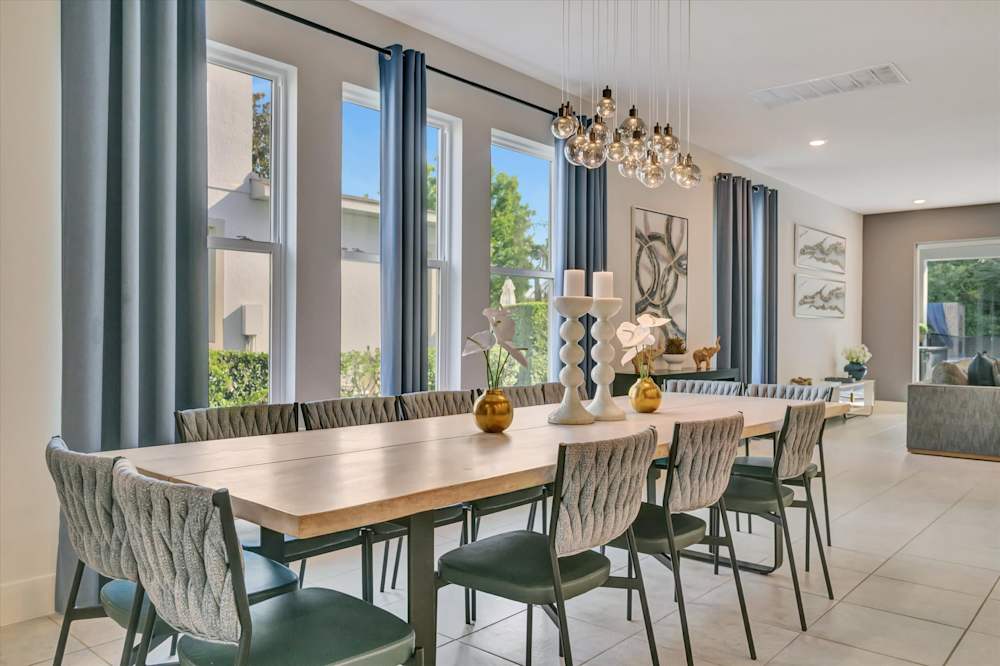 Ten-seat dining table beneath a crystal chandelier