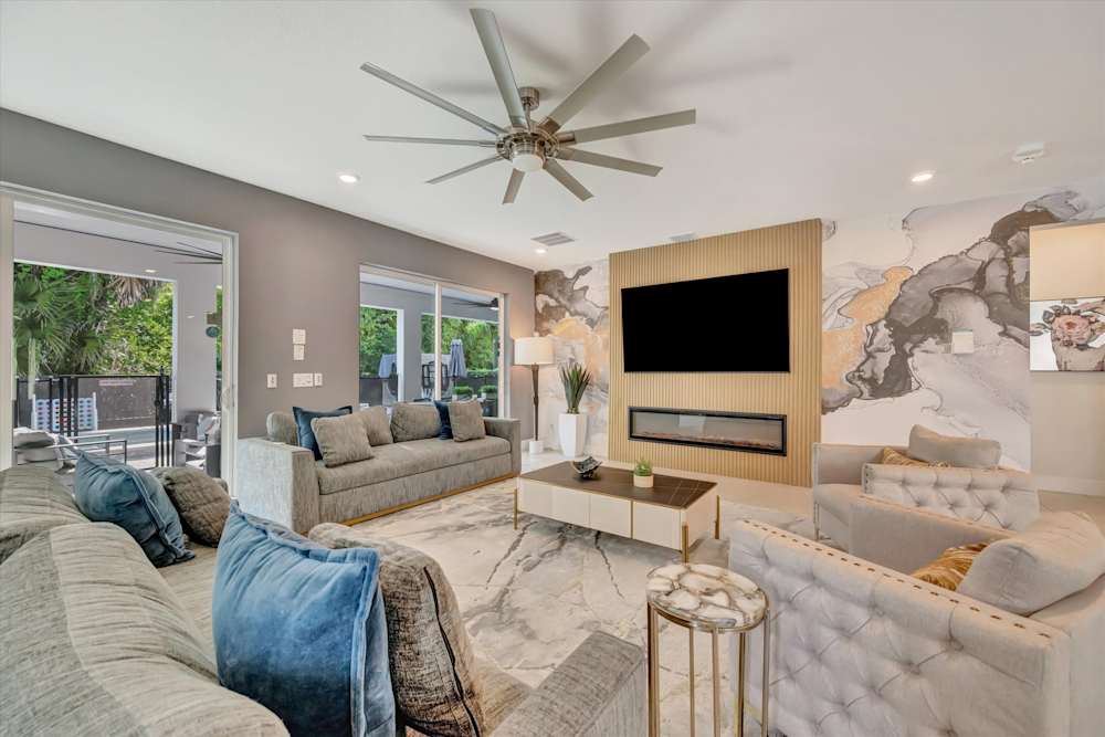 Curved sectional facing the fireplace and wall-mounted TV