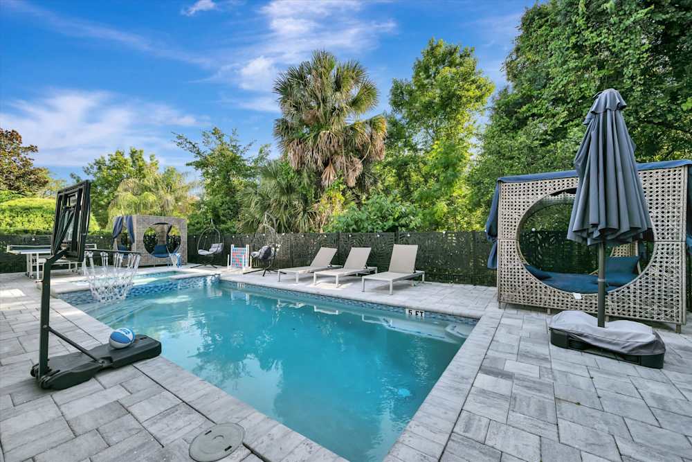 Pool loungers line the private resort-style pool