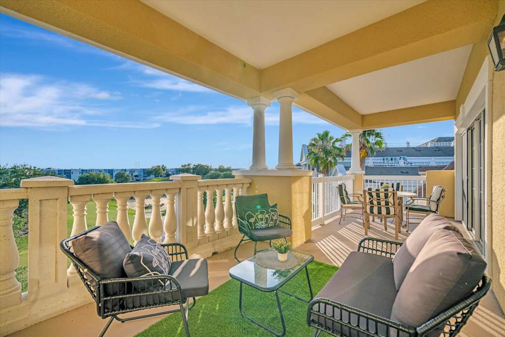 Covered balcony with cushioned seating and golf views