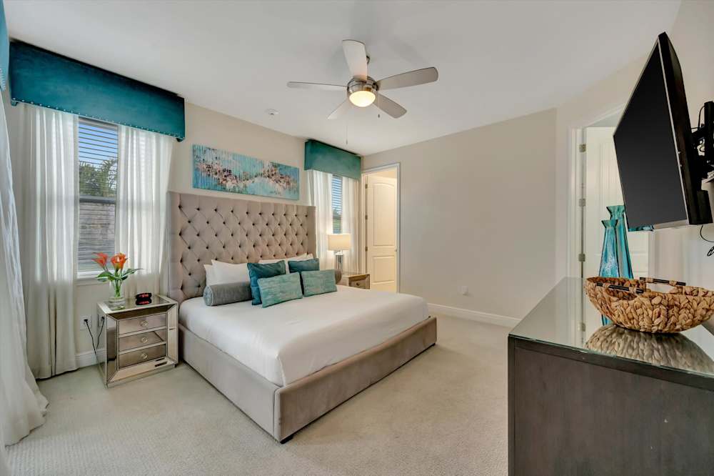 King bed with turquoise upholstered headboard