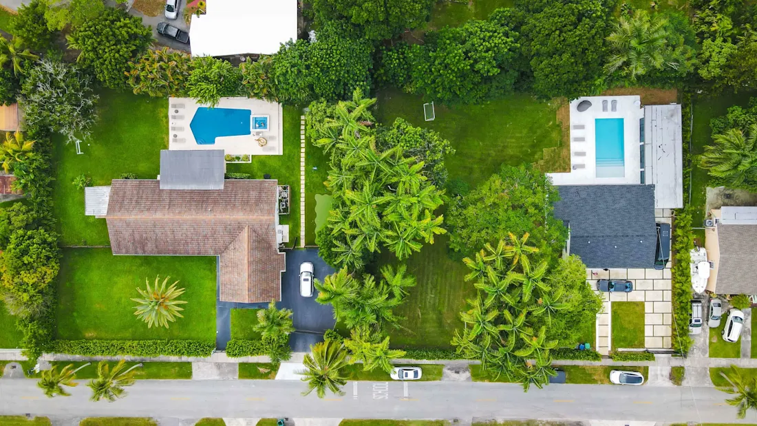 Aerial view of the two neighboring villas, their pools and connected backyards