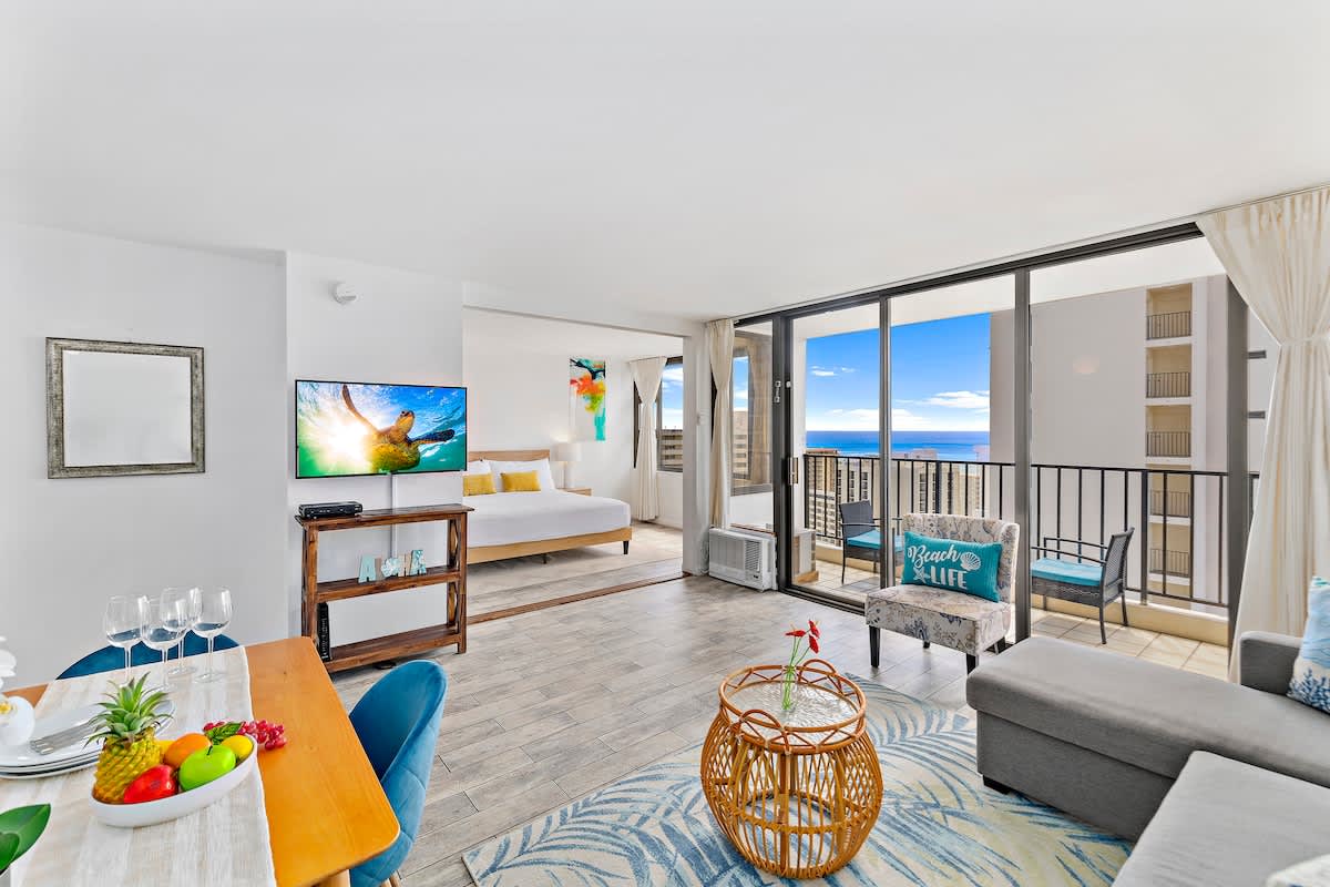 Cozy living room with great ocean view from the lanai, a window AC, cable TV, and a sliding door that separates the bedroom to the living room