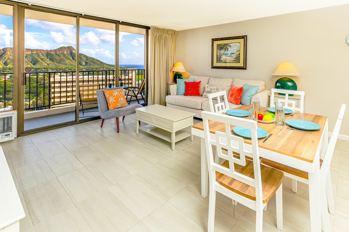 Bright living and dining area with mountain views from the balcony