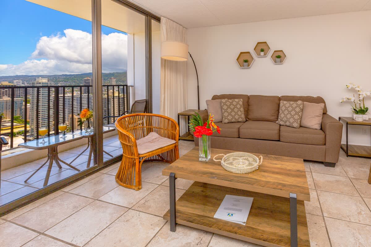 Relax in this cozy living room with city views from the balcony.