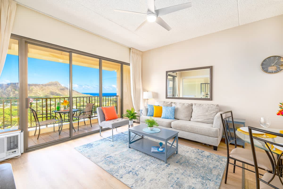 Bright living room with ocean and mountain views from the balcony