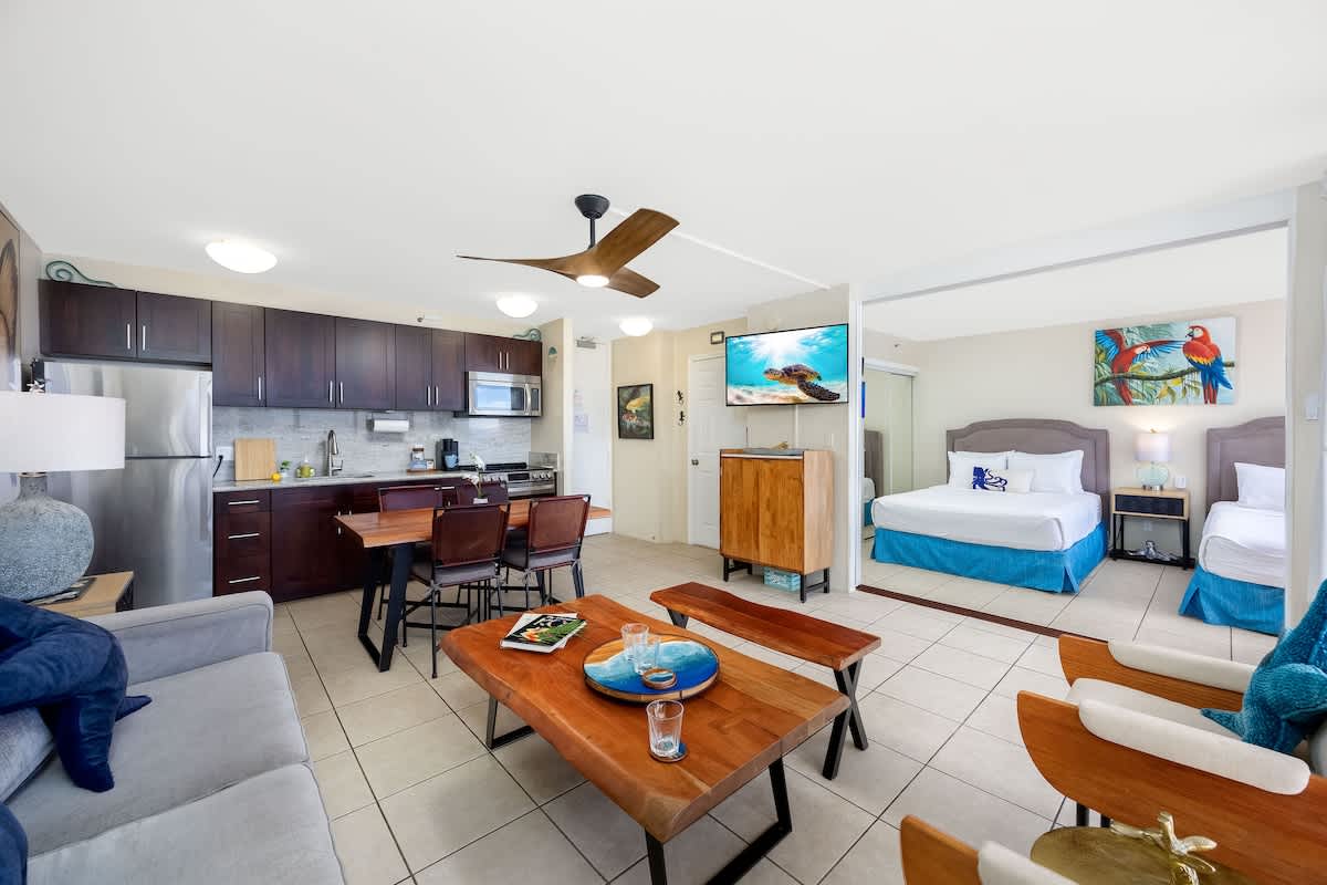 Settle right in! Your tropical escape awaits, complete with a full kitchen, comfy living space, and a bedroom with 2 queen beds!