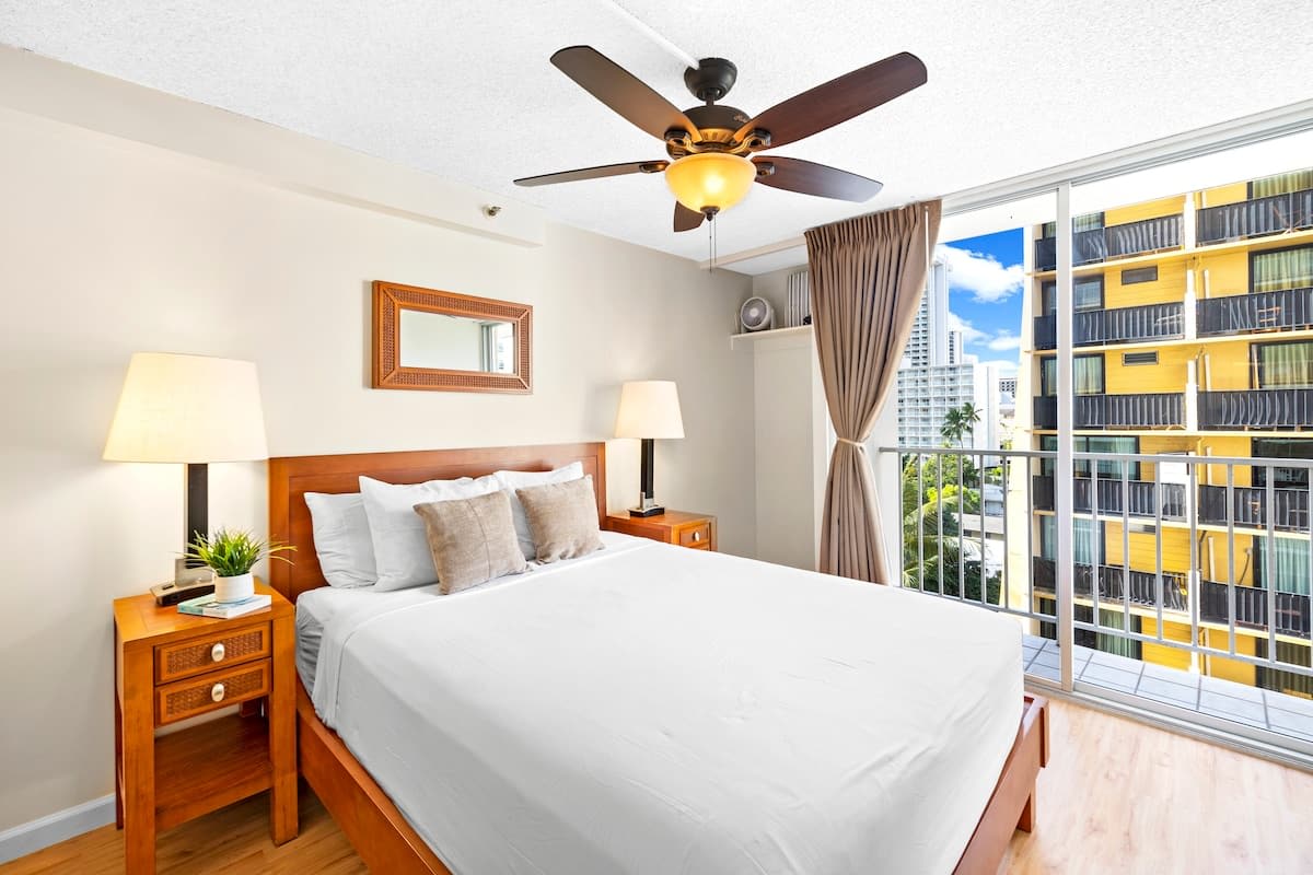 Relax in your bedroom with a queen-size bed, ceiling fan, nightstands, and blackout curtains.