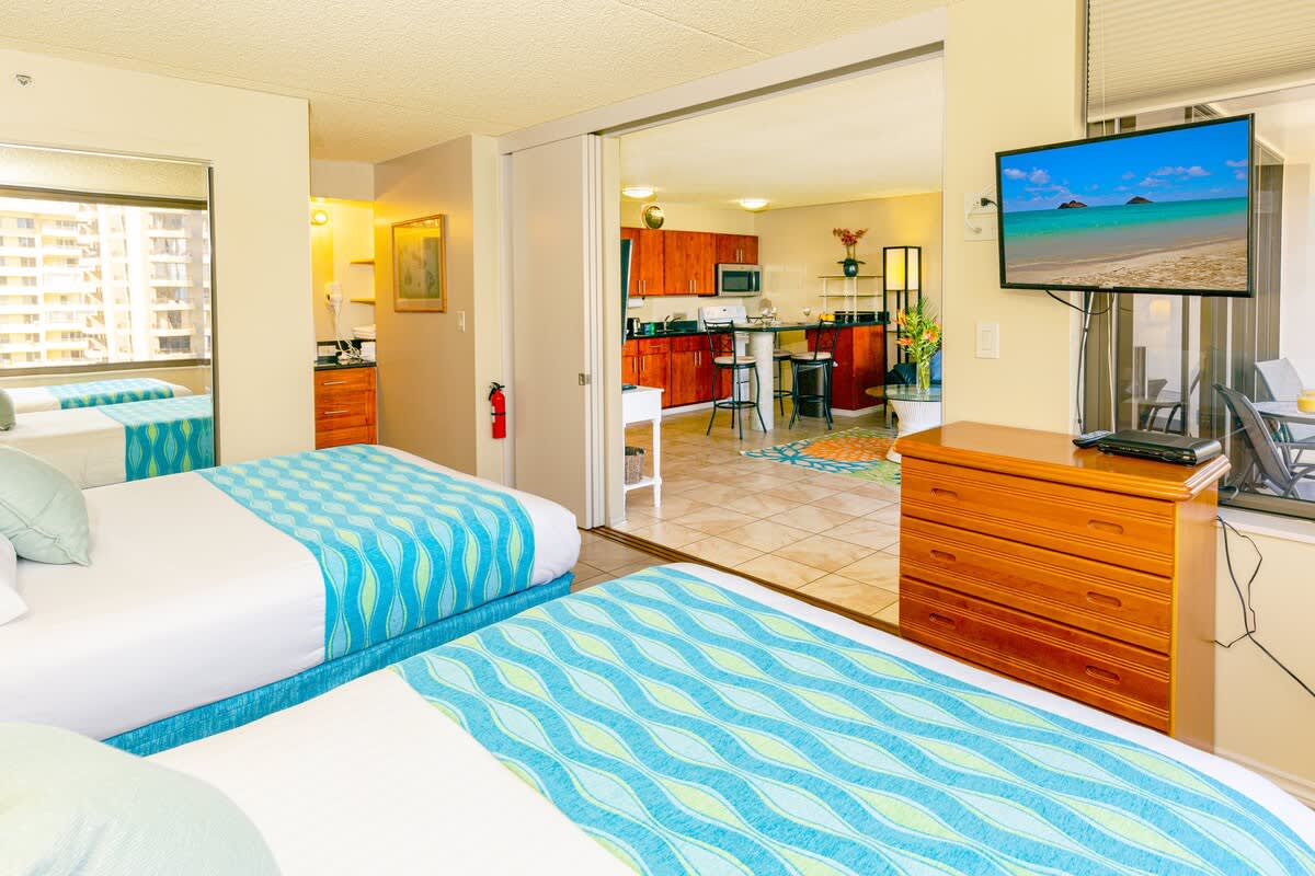 Bedroom with one queen-size and one full-size bed, closet,  and bathroom access