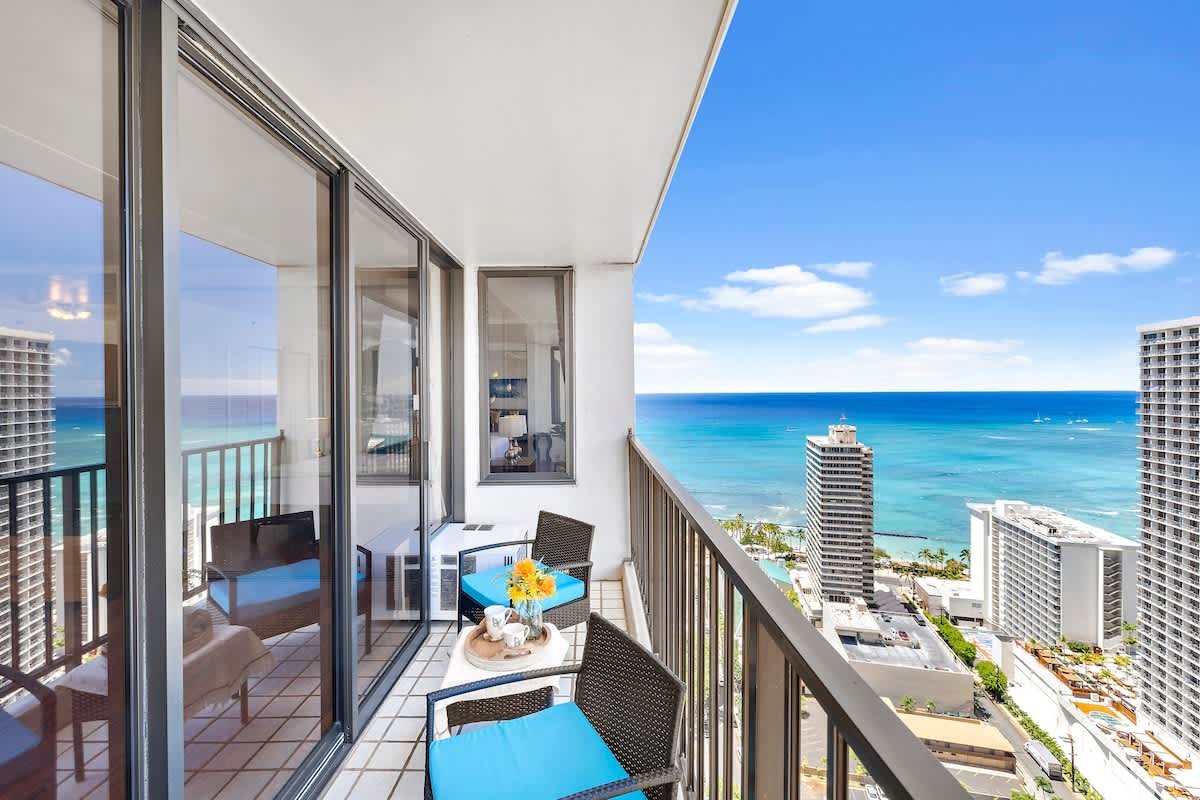 Relax on the balcony with ocean views and comfortable seating.