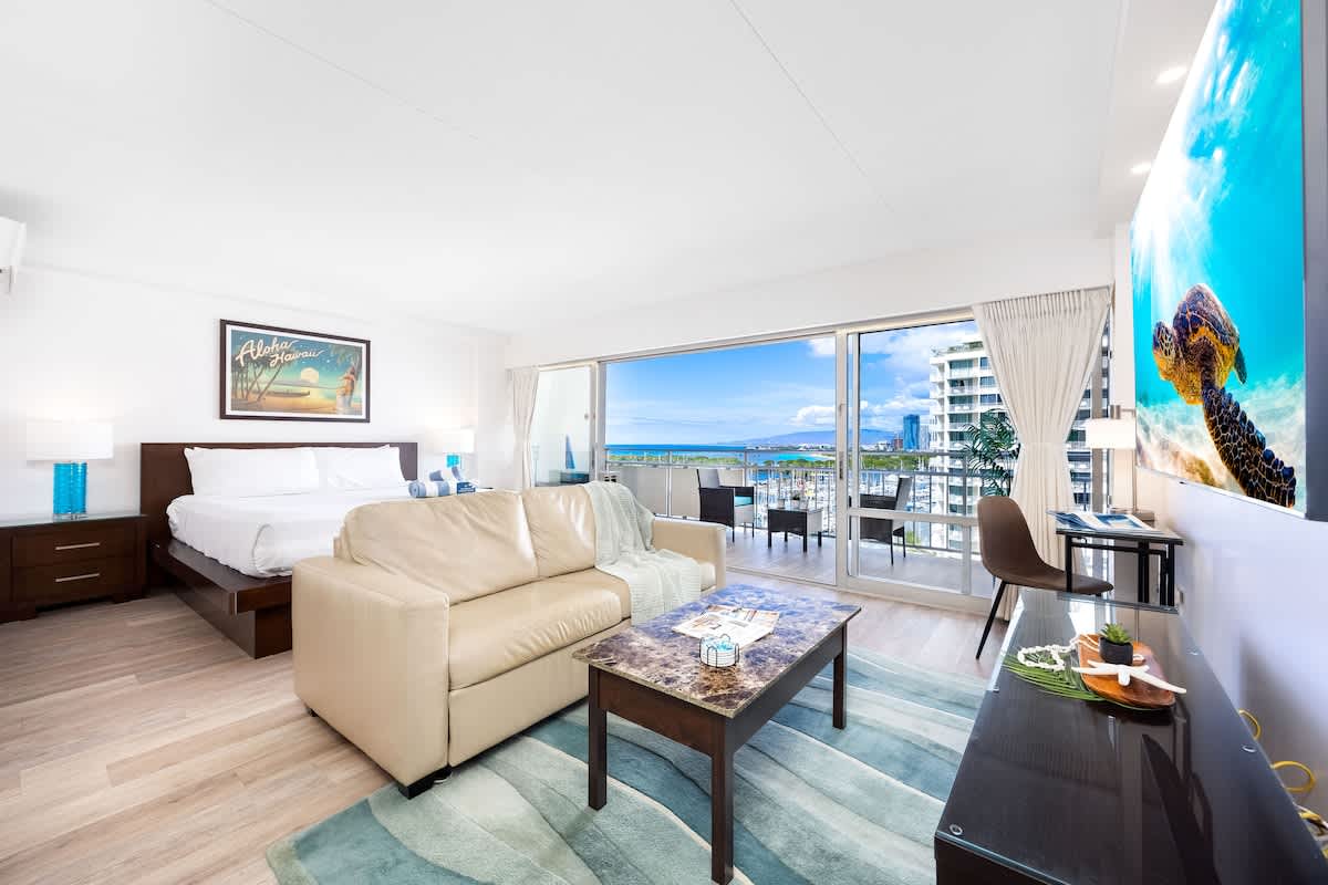 Enjoy your stay in this bright, modern studio at Ilikai featuring a king bed, sleeper sofa, and a private lanai with stunning harbor and ocean views.