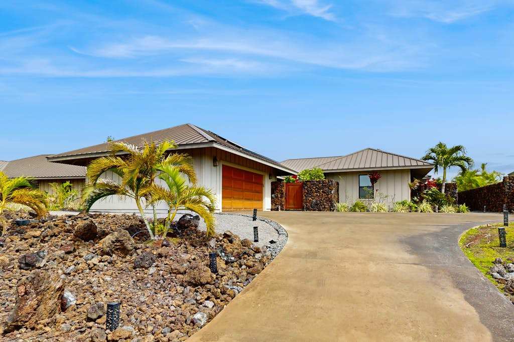 Front Elevation & Driveway Approach Surrounded by Tropical Landscaping