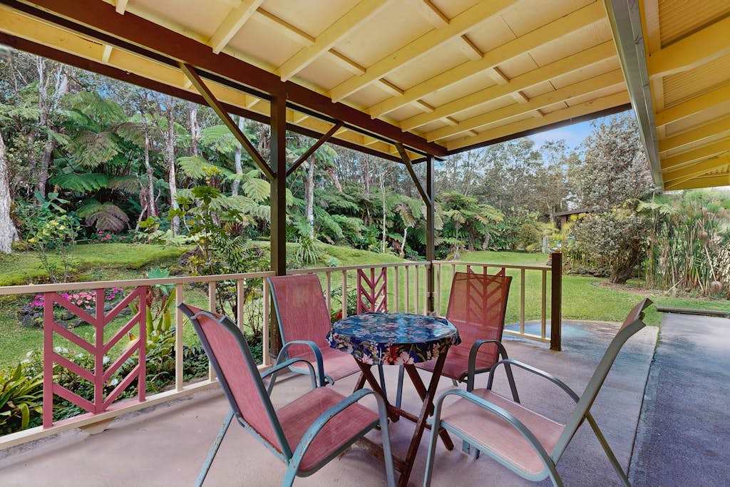 Covered Patio Seating Area Overlooking Lush Garden & Tropical Greenery