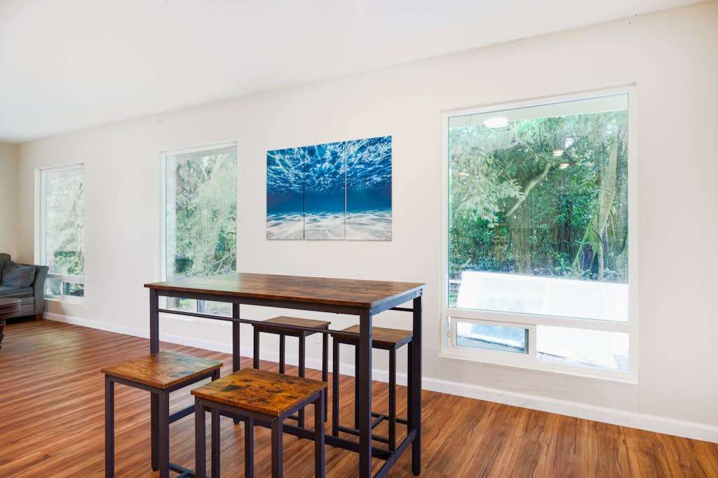 Dining room table with seating for four.  Very open feel and lots of light from the windows.  