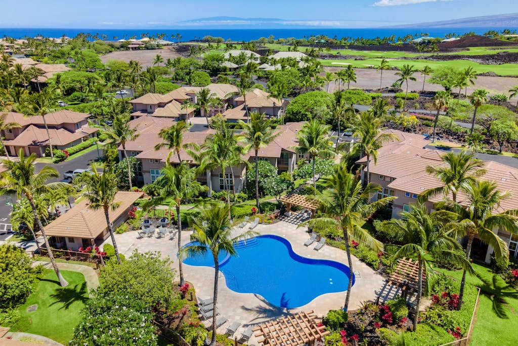 Panoramic Aerial Vista Of Lush Resort Grounds And Pool