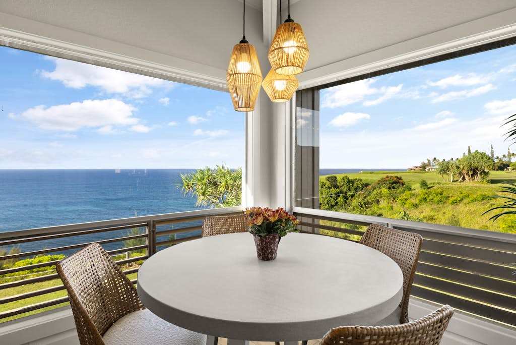 Oceanview lanai dining area overlooking the coastline
