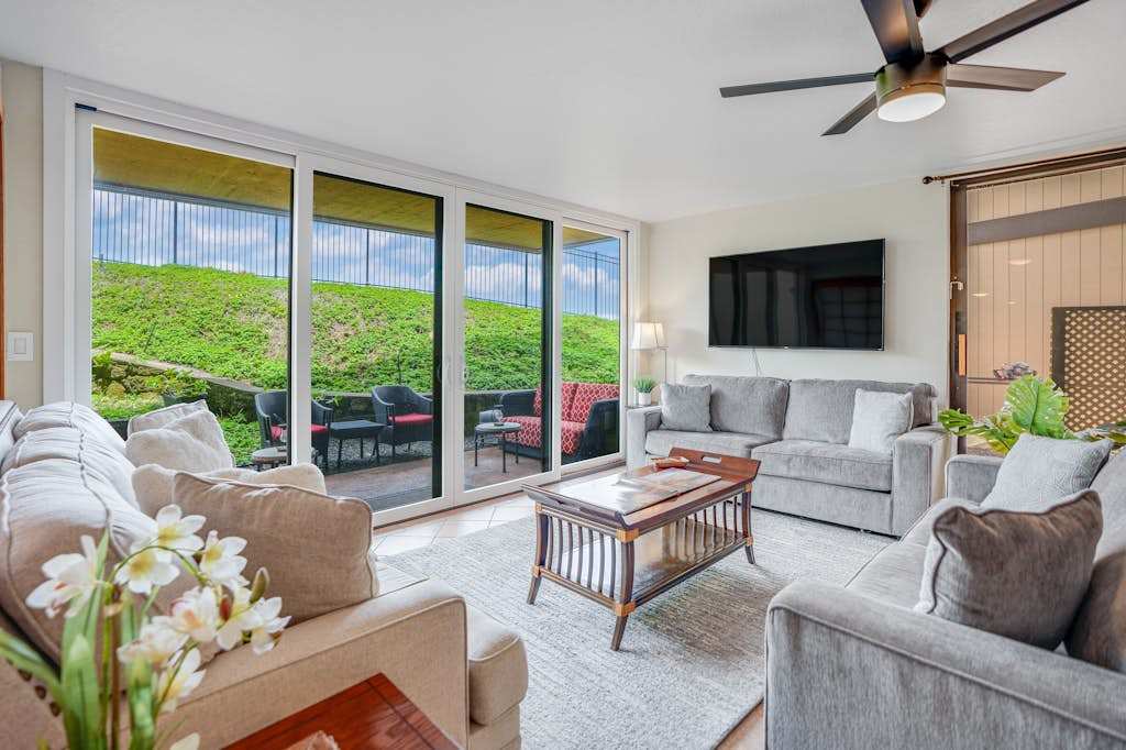 Bright, well-lit living room area with large television