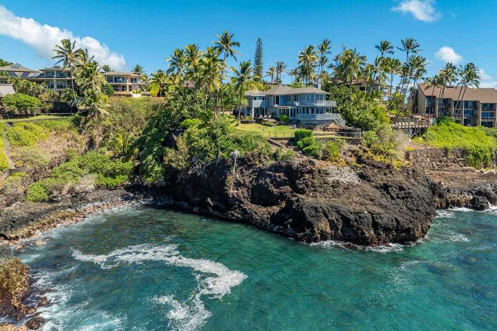 View of the coastline as the waves crash into the cliffs below the home.