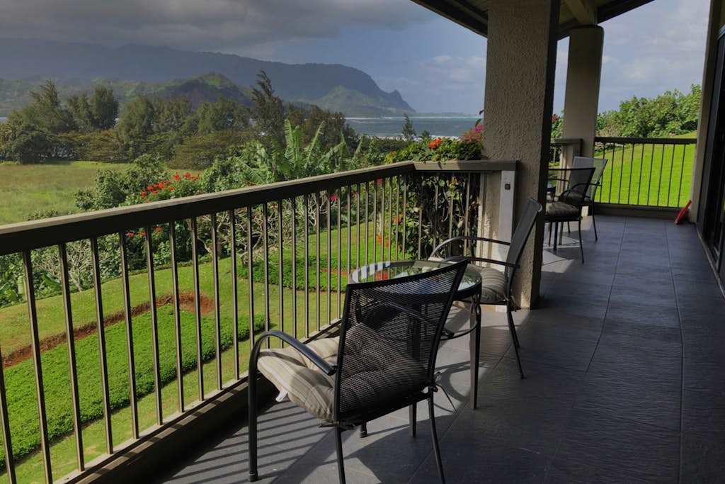 Covered balcony offers seating, garden views, and peaceful outdoor relaxation