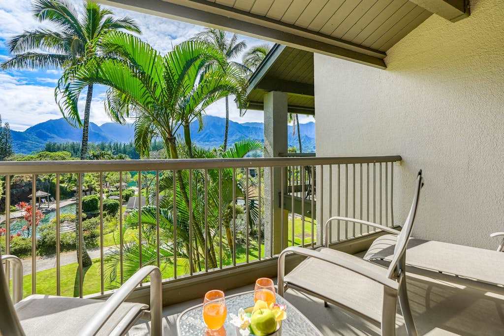 Covered balcony provides seating, mountain views, and refreshing tropical scenery