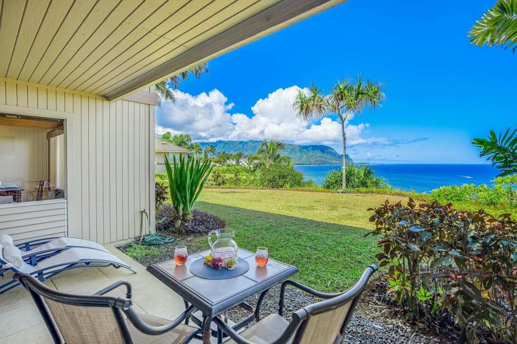 Covered patio showcases tiled flooring, bistro seating, and mountain views