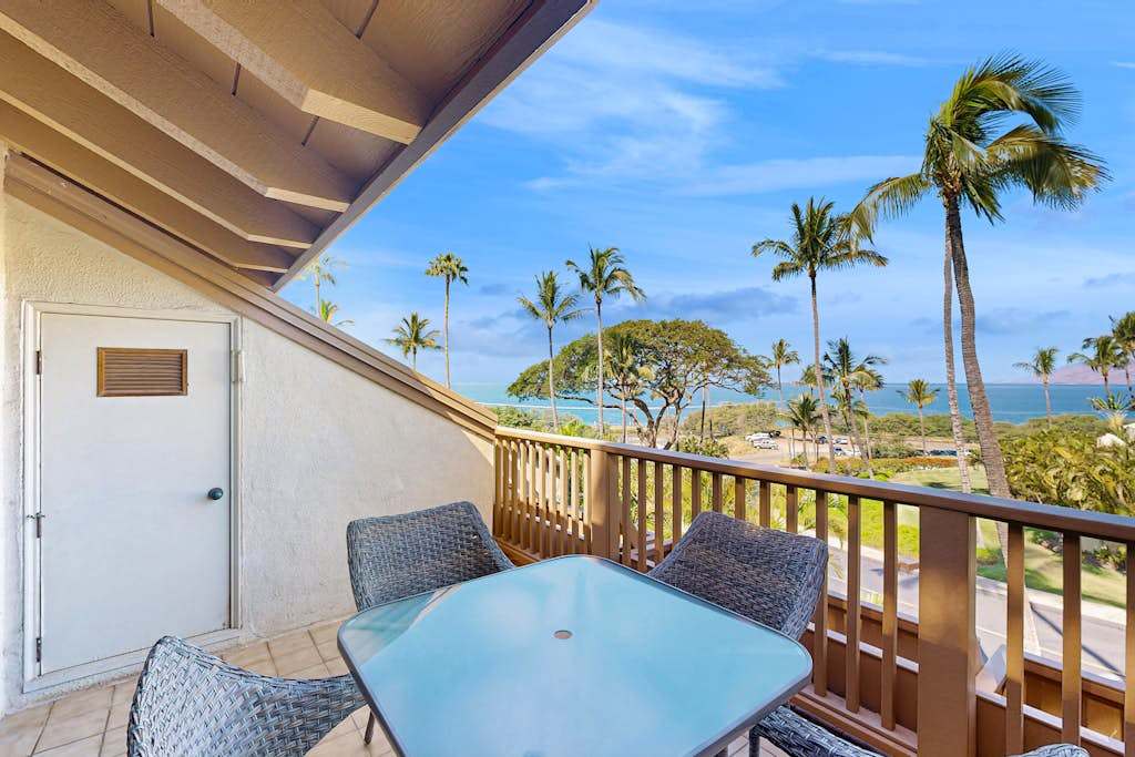 Covered Private Balcony Dining Table with Panoramic Ocean and Palm Tree Views