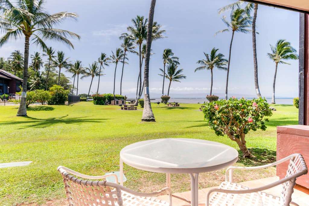 Tropical resort grounds surround comfortable outdoor spaces with inviting island views