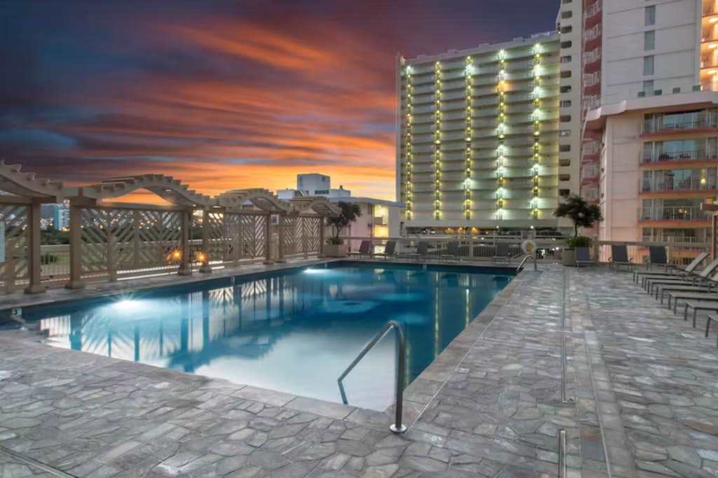 Unwind by the pool as the sun sets over the horizon