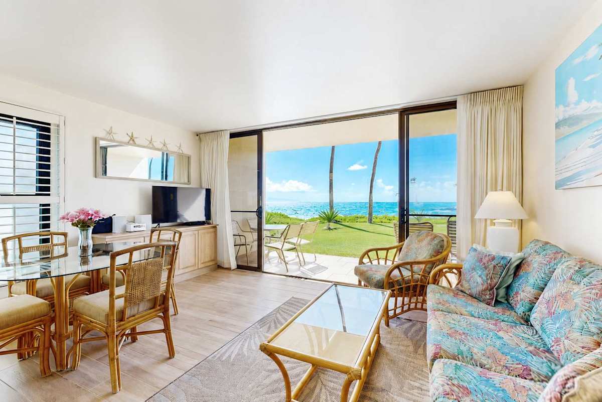 Living room with sleeper sofa and flat screen tv. Views of the turquoise waters from comfort of your couch.