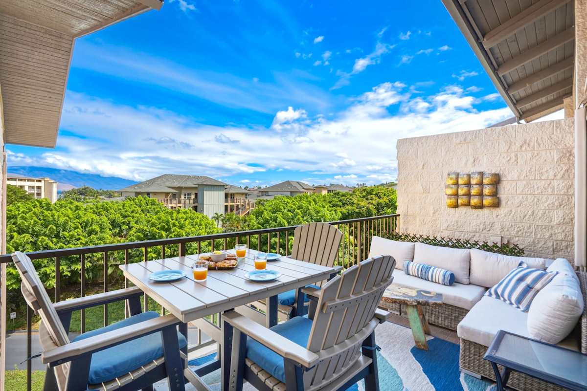 Step outside to your private partially covered lanai, complete with an outdoor dining set and comfy sectional seating overlooking lush tropical views.