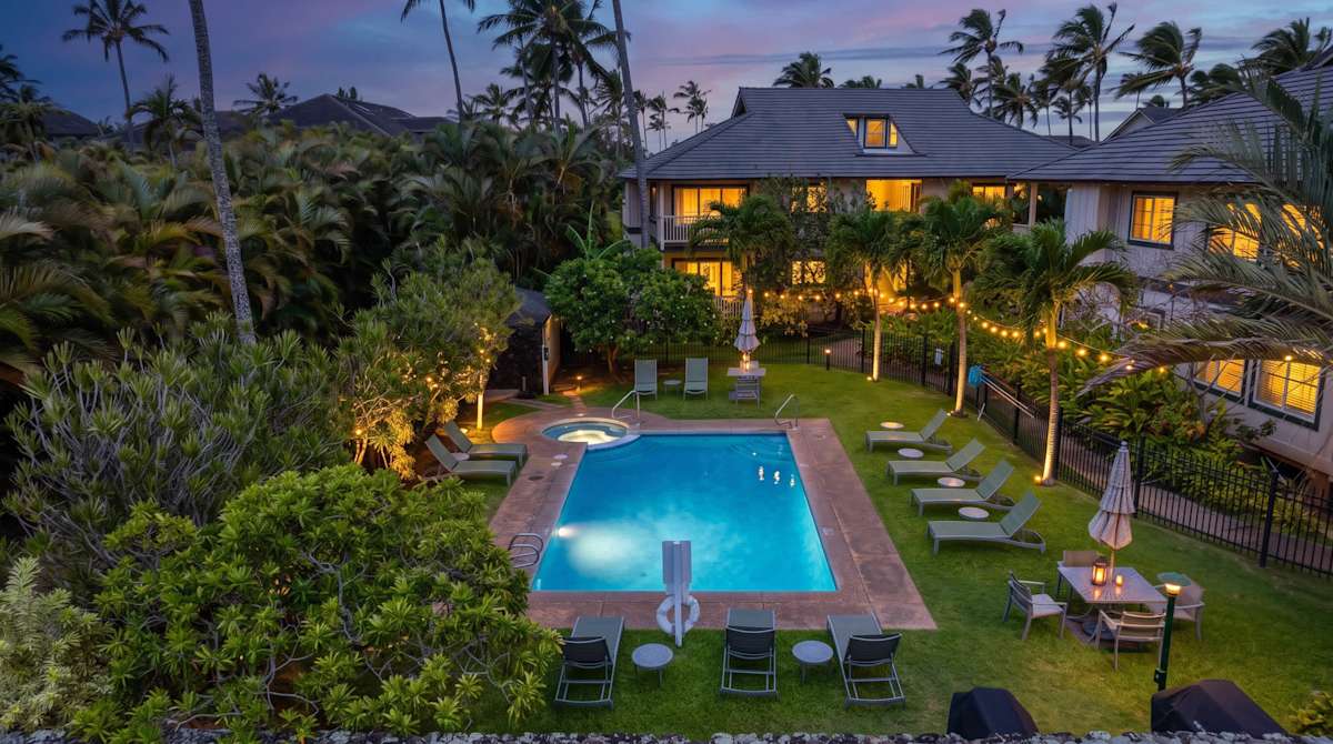 Twilight View of the Estate with Glowing Pool and String Lights