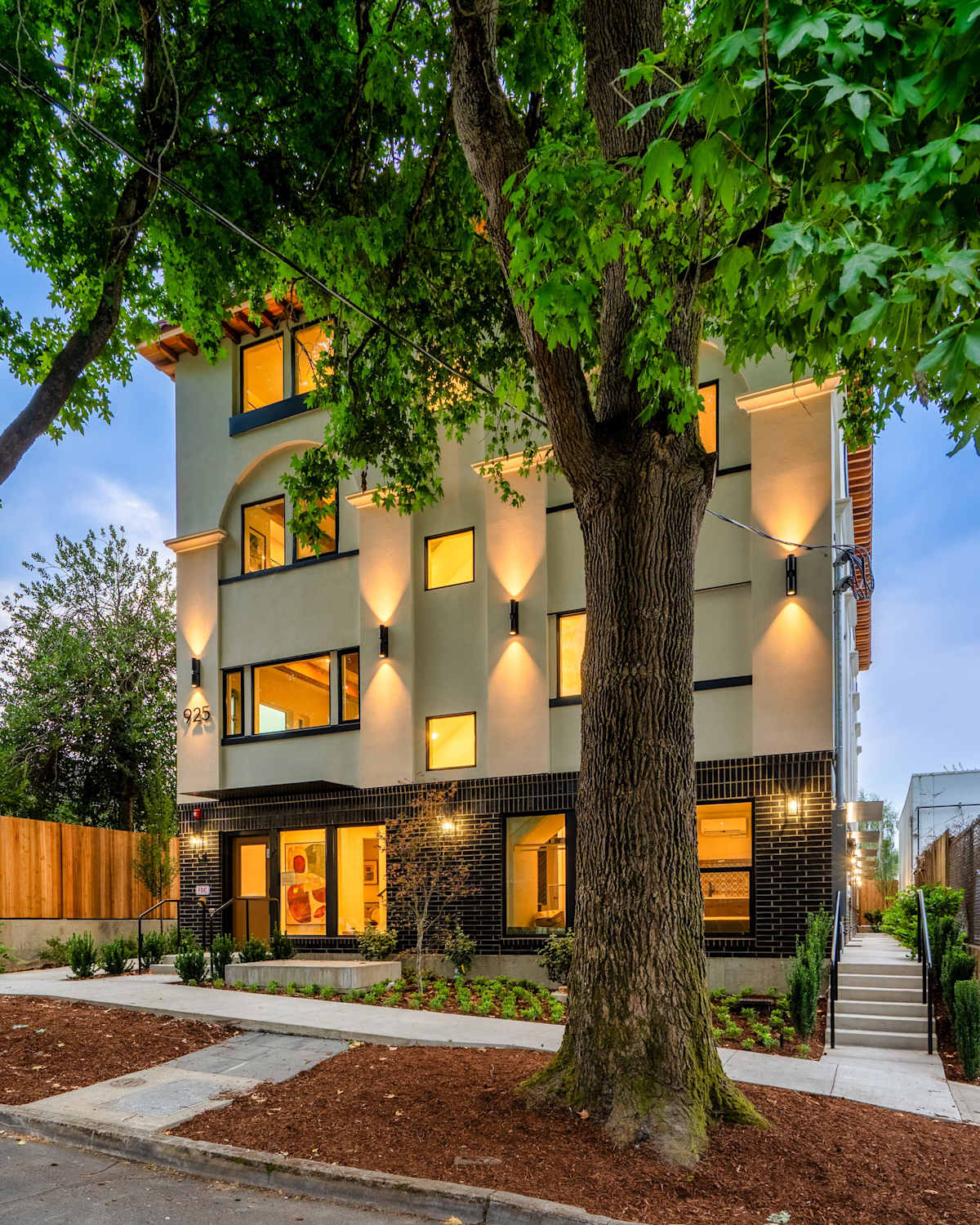 A three-story building with a tree in front of it