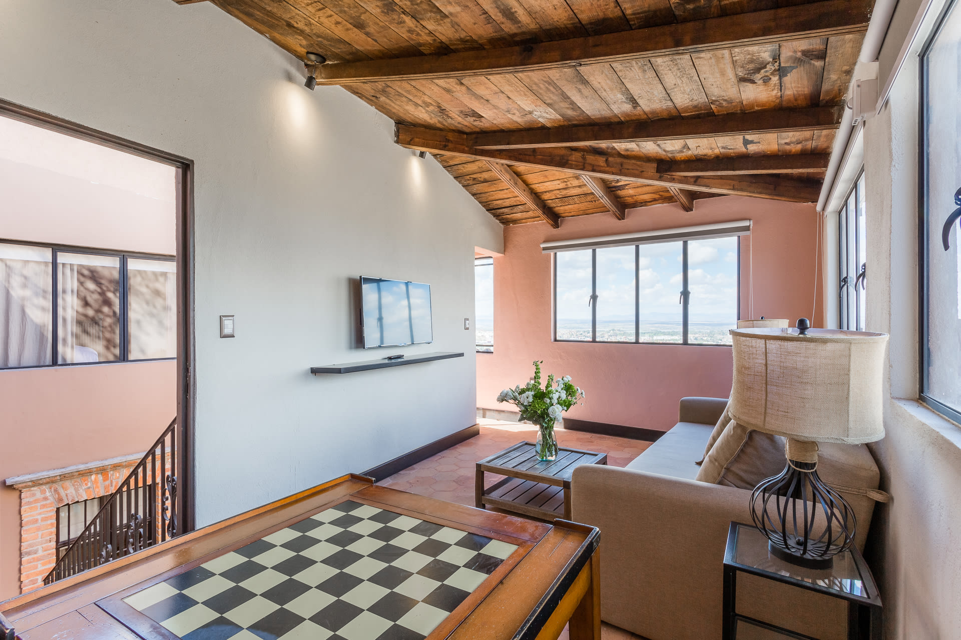 Living room with chess board and mounted TV