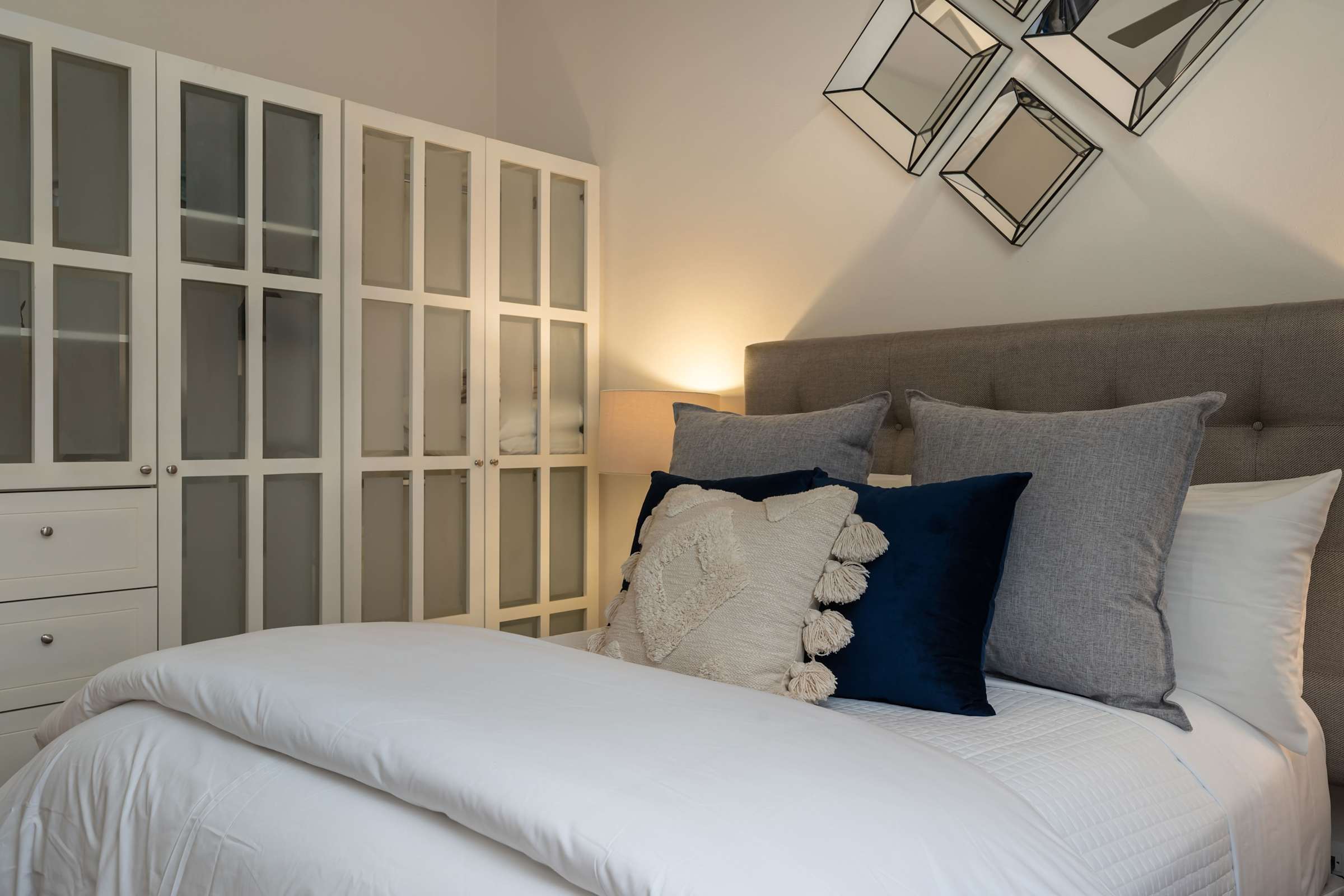 Guest bedroom with queen bed and closet