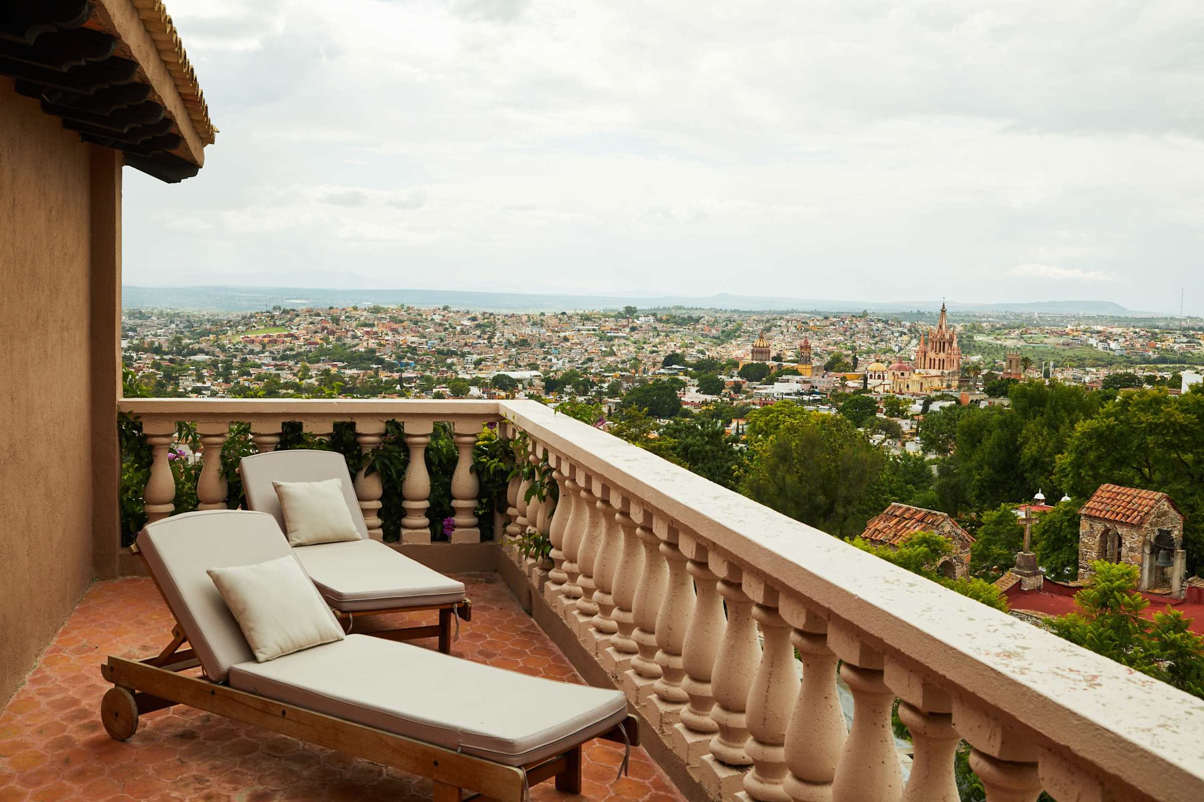 Balcony with lounge chairs overlooking the city