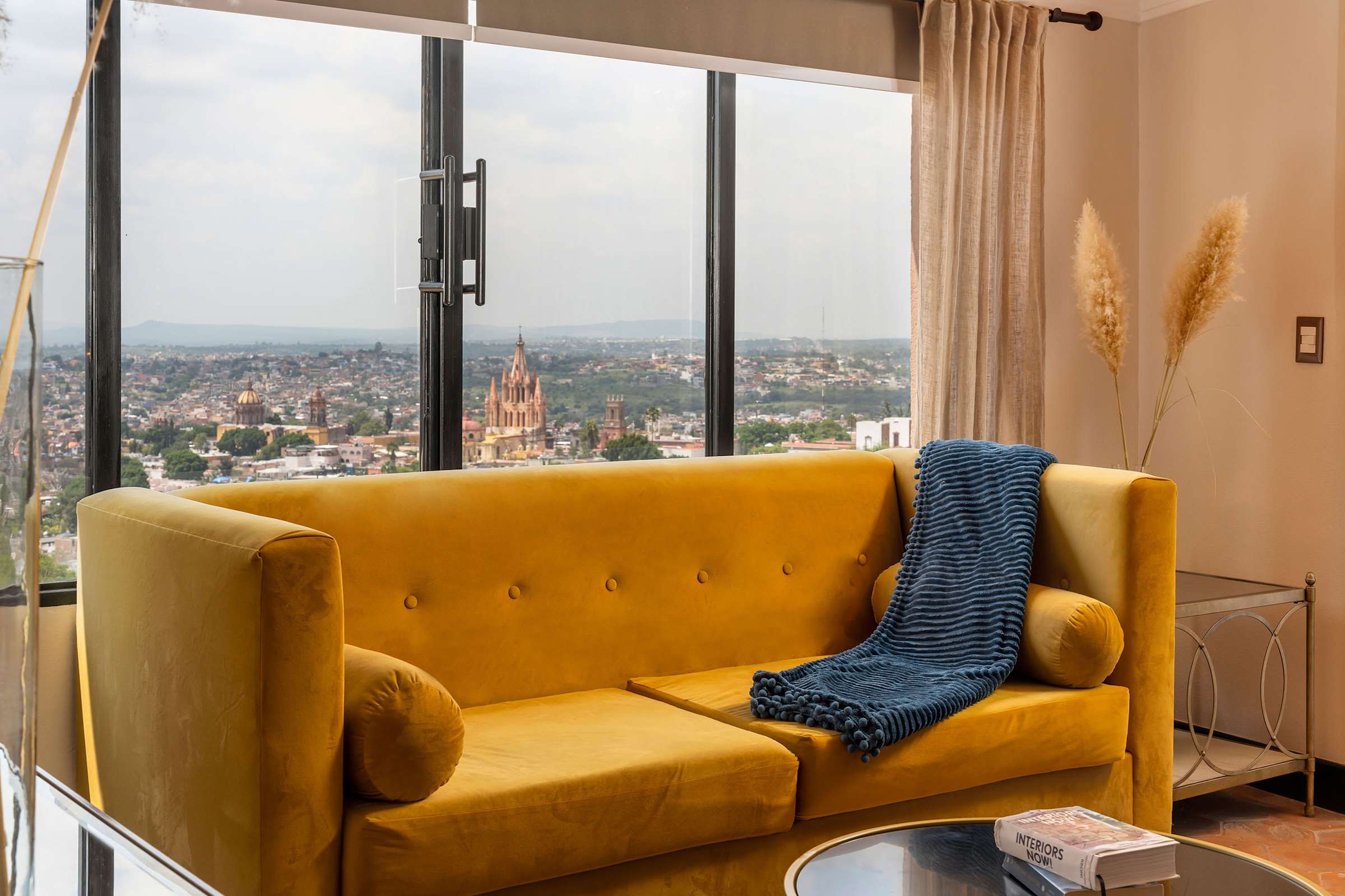 Yellow sofa in the bedroom with panoramic city views