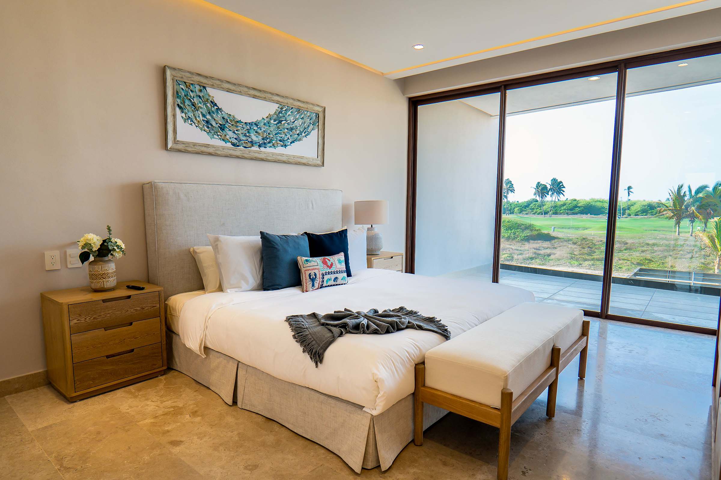 Bedroom 4 with a king bed, blue accent decor, and sliding doors leading out to the golf course view