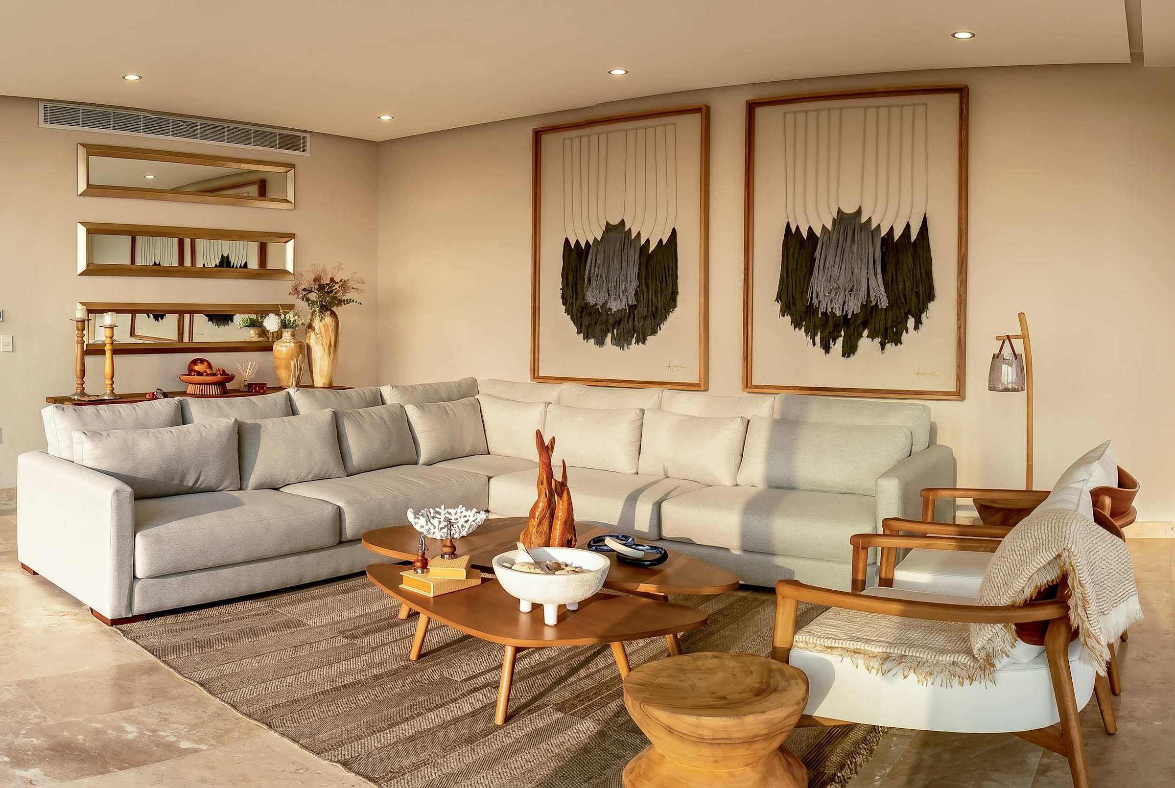 Spacious living room with plush sofas, statement artwork, and marble floors — an elegant space to relax and socialize