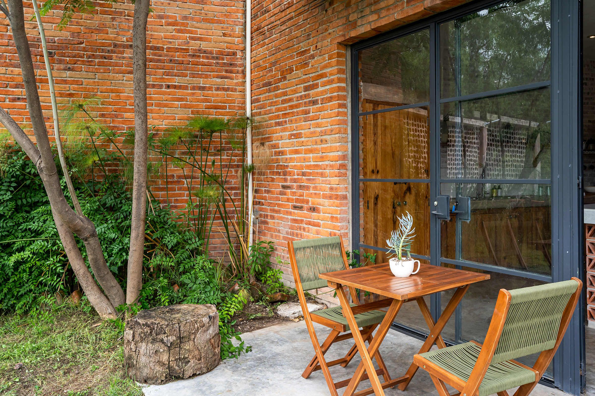 Private garden patio with outdoor table and chairs