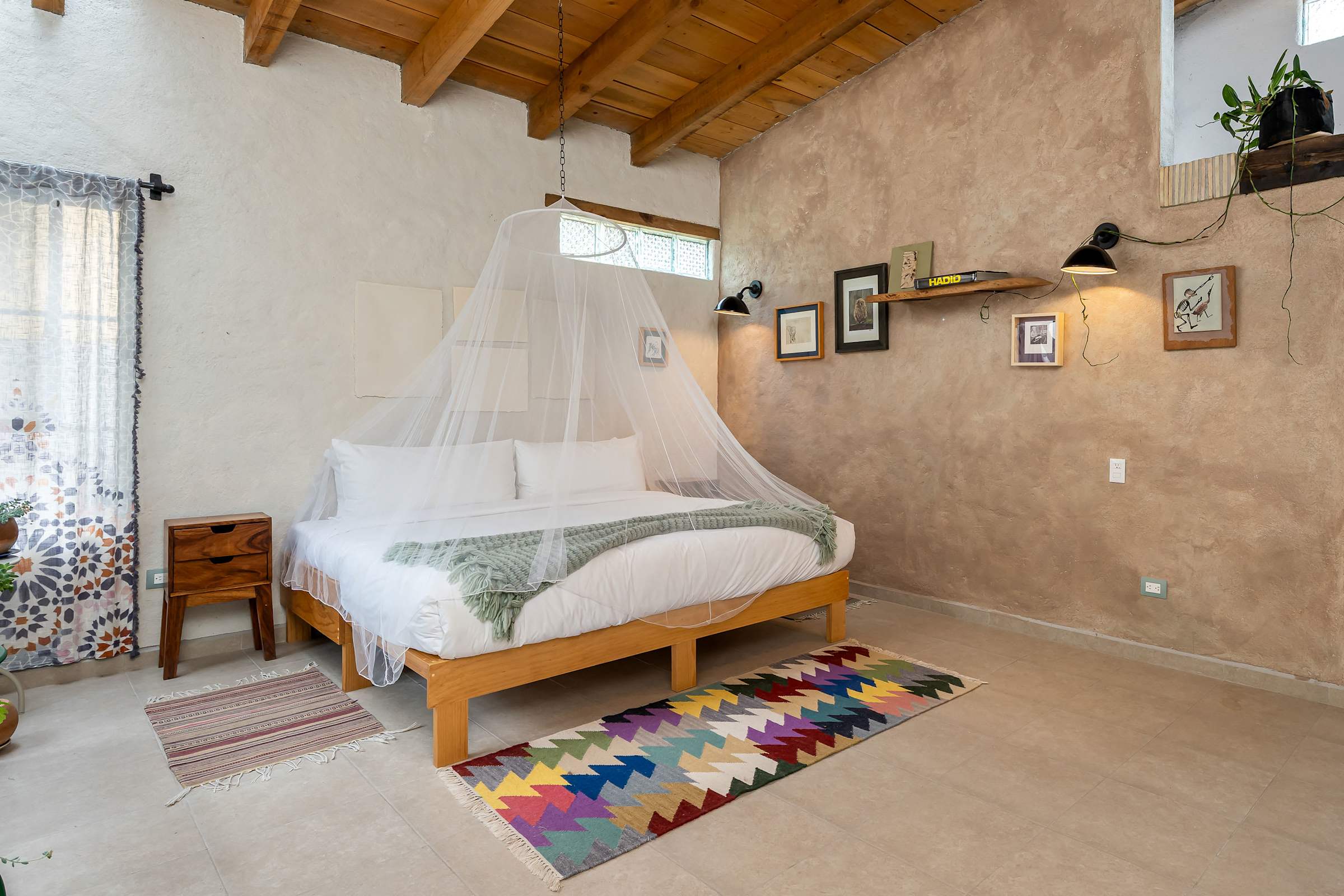 King bed with wood-beam ceiling