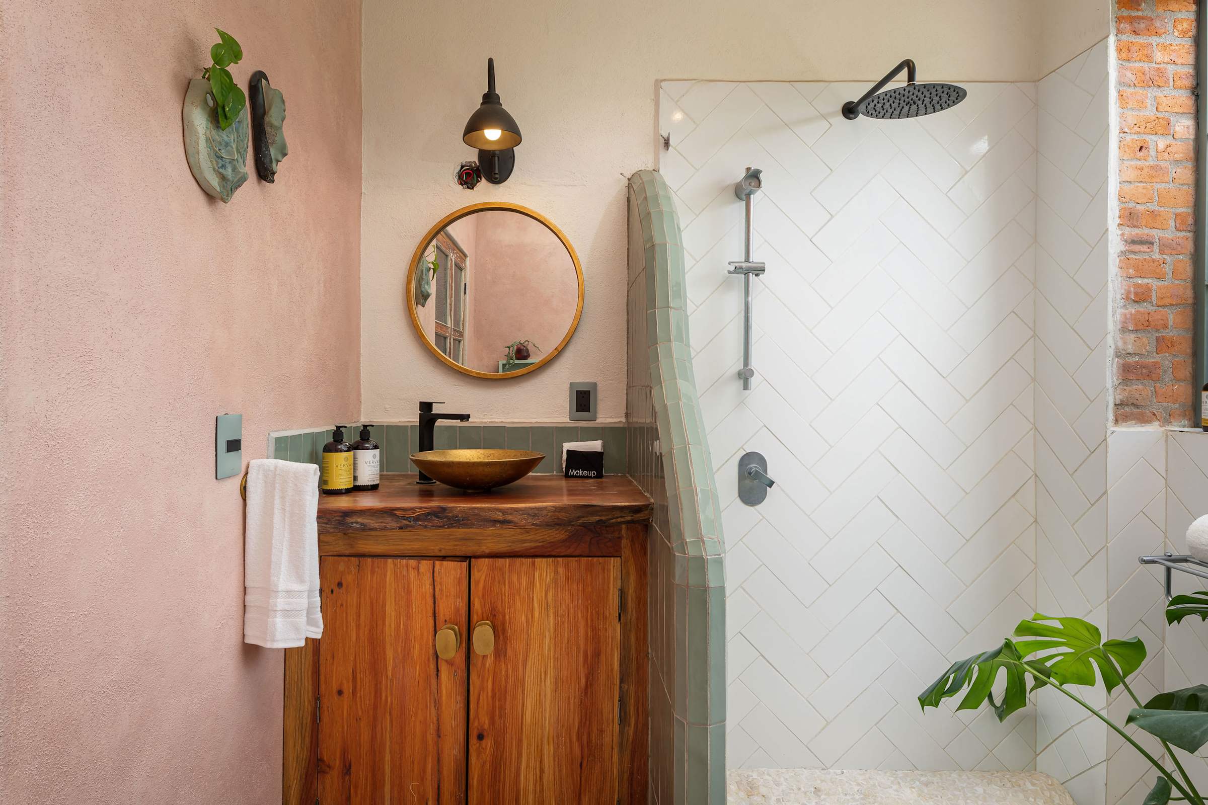 Bathroom vanity and walk-in shower with herringbone tile