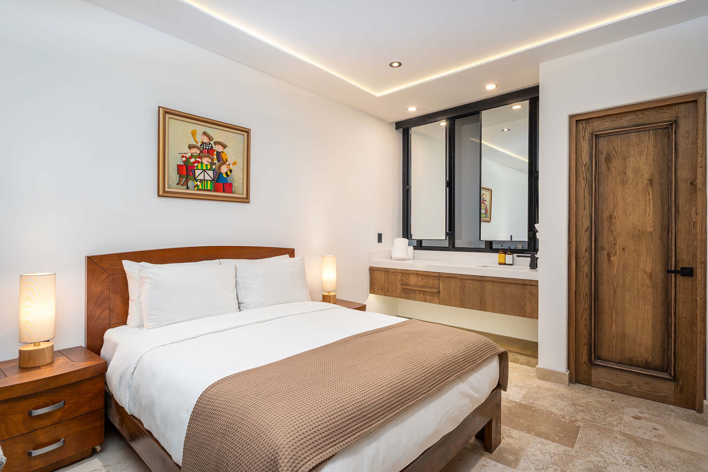 Queen bed with hotel-quality linens and bathroom vanity